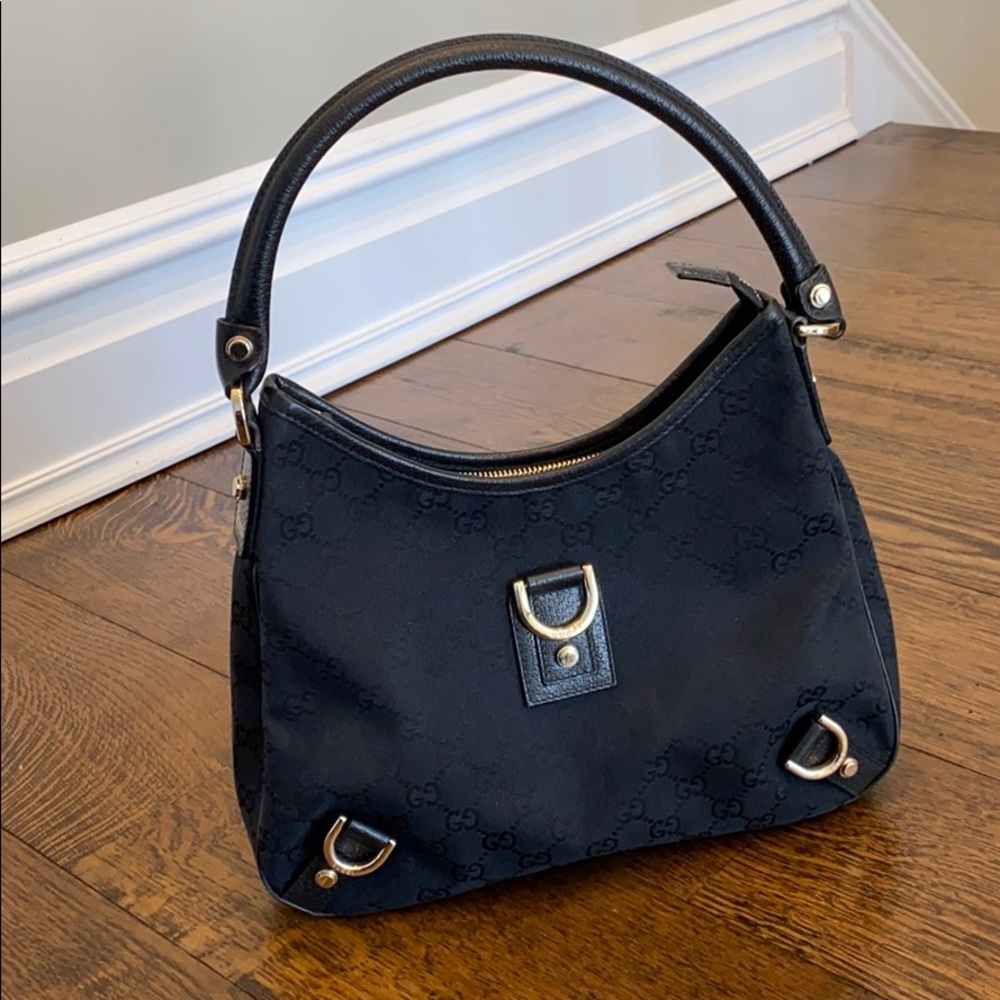 Black Vintage Gucci handbag with silver buckles.